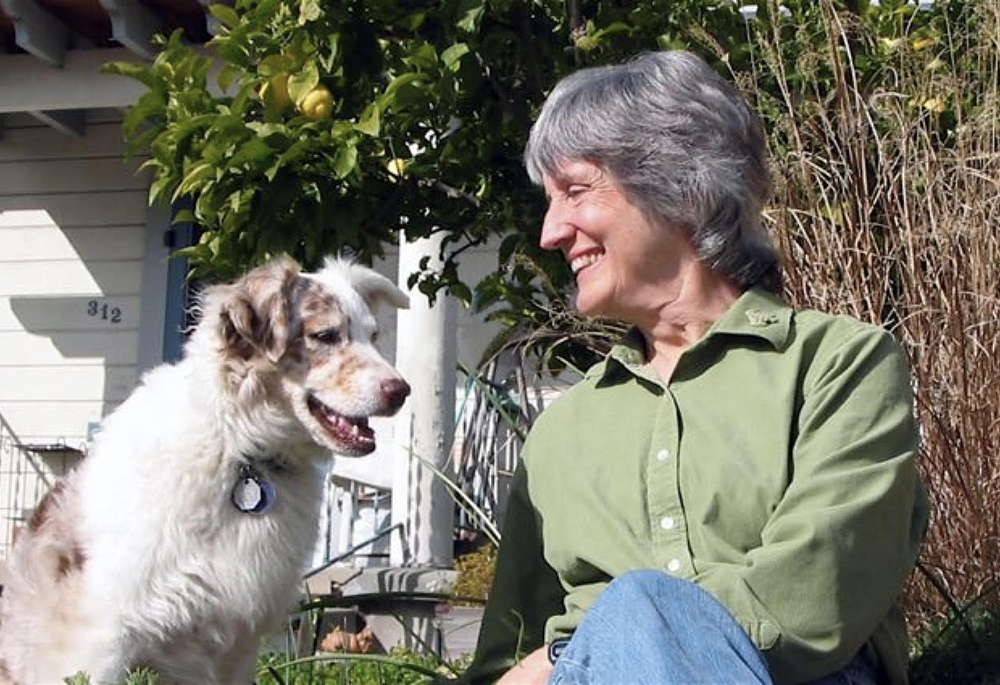 Donna Haraway and her dog, Cayenne, are pictured at home in 2007. The phrase "contact zone," cited by Pope Francis in Laudate Deum, is from a chapter in Haraway's 2008 book When Species Meet that explores their experience training Cayenne in agility, a sport where a dog and a human handler navigate an obstacle course. (Rusten Hogness)