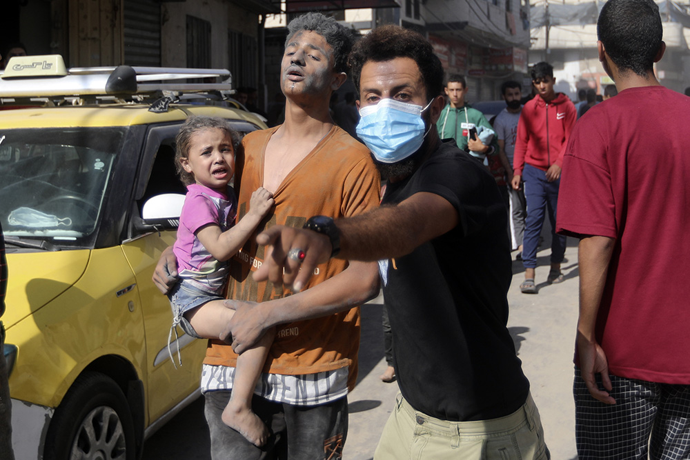 Injured Palestinians are evacuated following Israeli airstrikes on the town of Khan Younis, southern Gaza Strip, Oct. 26. (AP/Mohammed Dahman)