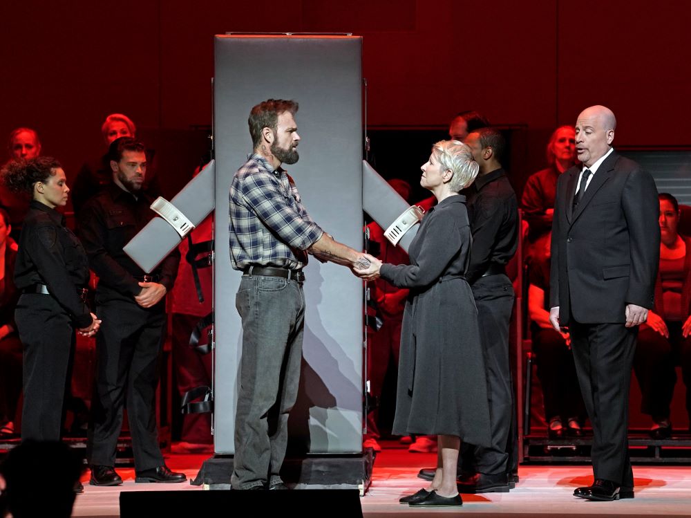 Ryan McKinny portrays inmate Joseph De Rocher, Joyce DiDonato portrays Sr. Helen Prejean, and Raymond Aceto portrays warden George Benton in Jake Heggie's "Dead Man Walking." (Met Opera/Karen Almond)