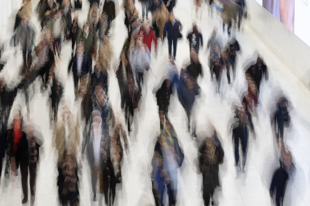 Commuters walk along a corridor in the World Trade Center in New York on Nov. 18, 2019. Thirty percent of Americans don't identify with a religious group — but not all of them are atheists or agnostics. In fact, 43% of the group known as the "nones" say they believe in God, even if they largely dislike organized religion. (AP/Mark Lennihan, File)