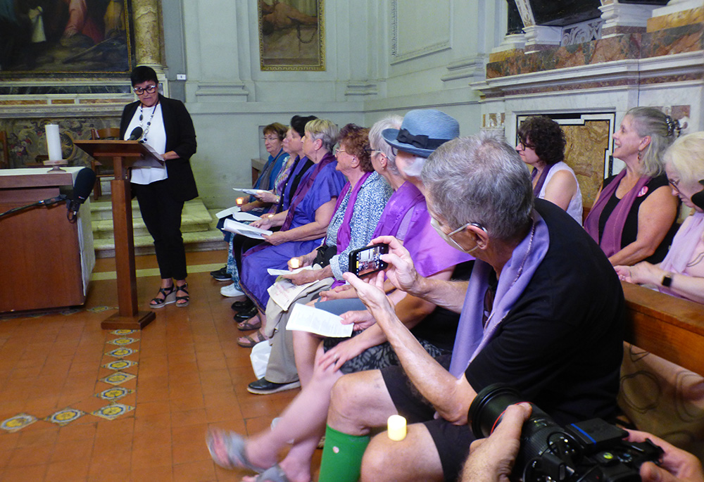 Patrizia Morgante, a member of the Italian group Donne per la Chiesa ("Women for the Church"), offers a testimony during the Oct. 3 "Let Her Voice Carry" prayer vigil hosted by women's ordination advocates at Rome's Basilica of Santa Praxedes. (NCR photo/Rhina Guidos) Participants in the Oct. 3 "Let Her Voice Carry" prayer vigil hosted by women's ordination advocates at Rome's Basilica of St. Praxedes. (NCR photo/Rhina Guidos)