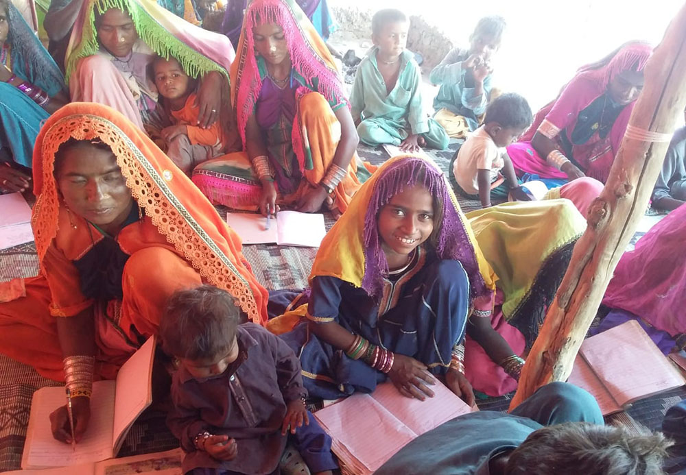 Women study in the literacy class during the floods in the province of Sindh in Pakistan in 2022. (Courtesy of Emer Manning)