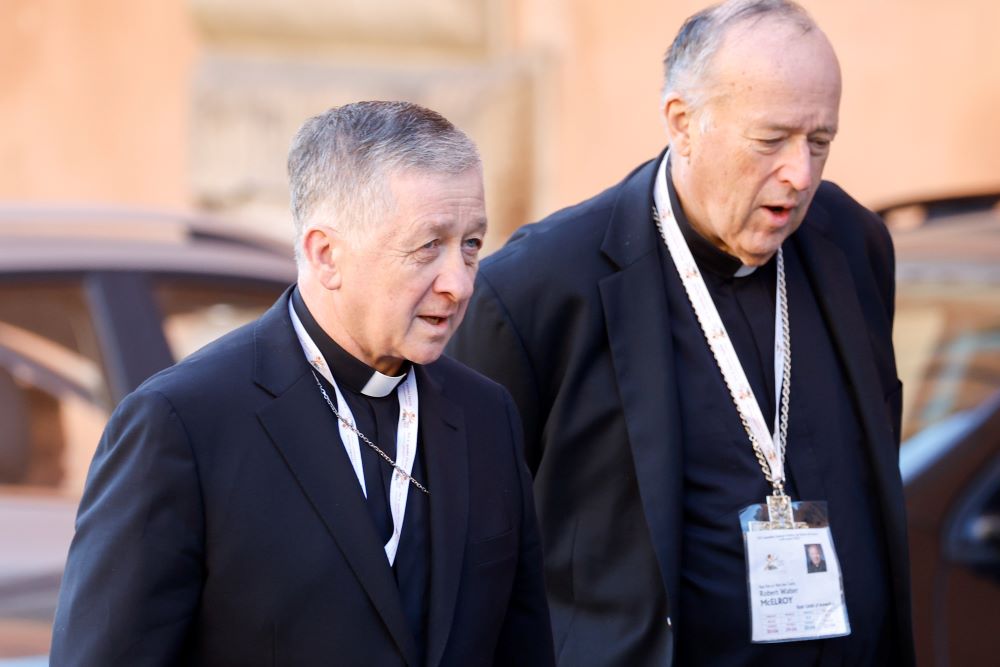 Cardinals Blase Cupich of Chicago (left) and Robert McElroy of San Diego arrive for a session of the assembly of the Synod of Bishops in the Vatican's Paul VI Audience Hall Oct. 17. (CNS/Lola Gomez)