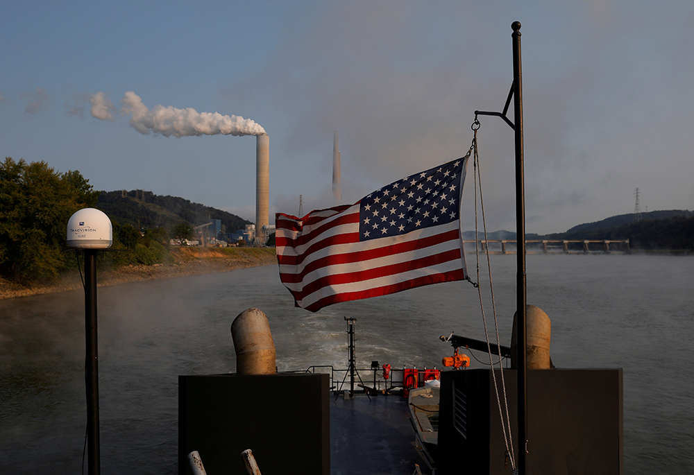 A towboat passes a coal-fired power plant along the Ohio River Sept. 10, 2017, in Stratton, Ohio. (CNS/Reuters/Brian Snyder)