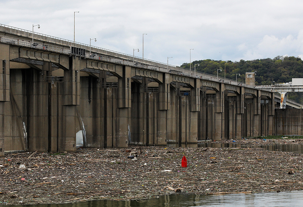 Garbage and debris pile up behind the Markland Locks and Dam on the Ohio River Sept. 14, 2017, in Florence, Indiana. (CNS/Reuters/Brian Snyder)