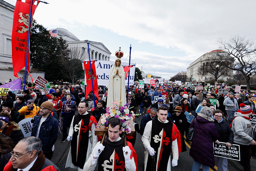 Pro-life demonstrators carry a statue of Mary during the annual March for Life in Washington Jan. 20, 2023. It was the first time the march was held since the high court overturned its 1973 Roe v. Wade abortion decision June 24, 2022. (OSV News/Reuters/Jonathan Ernst)