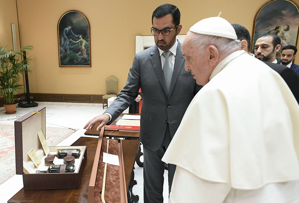 Pope Francis receives a gift from Sultan al-Jaber, the president-designate of the 2023 United Nations Climate Change Conference, known as COP28, during a meeting at the Vatican Oct. 11. (CNS/Vatican Media)