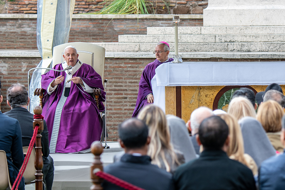 Pope Francis gives his homily during Mass at the Rome War Cemetery, the burial place of members of the military forces of the Commonwealth in Rome Nov. 2 for All Souls' Day. Archbishop Diego Giovanni Ravelli, master of papal liturgical ceremonies, right, looks on. (CNS/Paolo Galosi, pool)