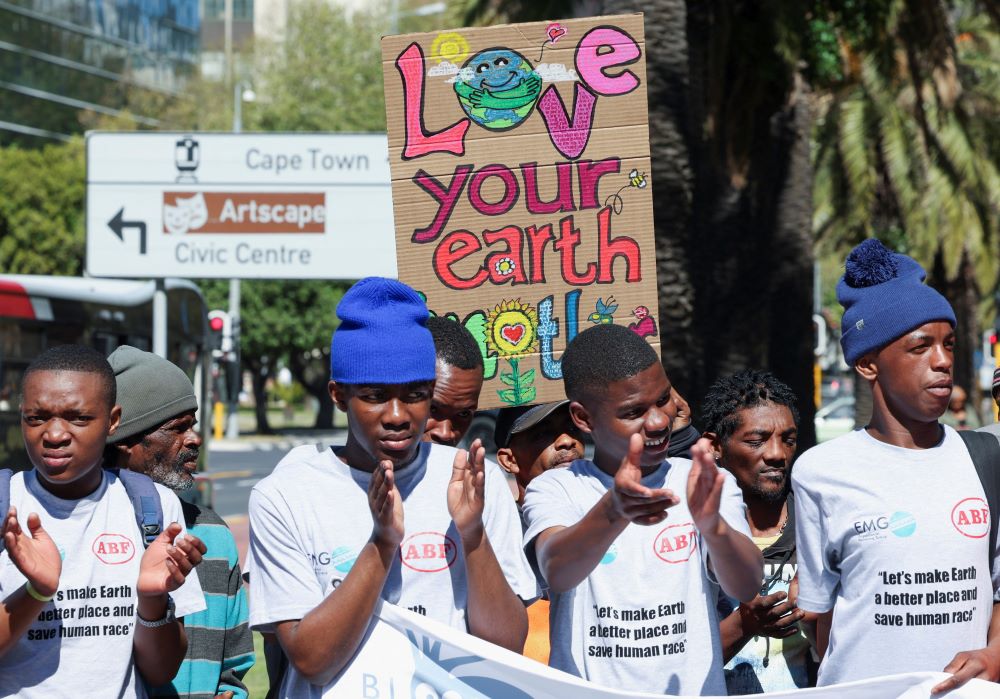 A climate activist holds a placard as demonstrators in South Africa gather outside the Cape Town International Convention Center Sept. 13, 2023, during the Southern Africa Oil and Gas Conference to call for climate justice resistance against oil and gas corporations and an end to fossil fuels. (OSV News/Reuters/Esa Alexander)