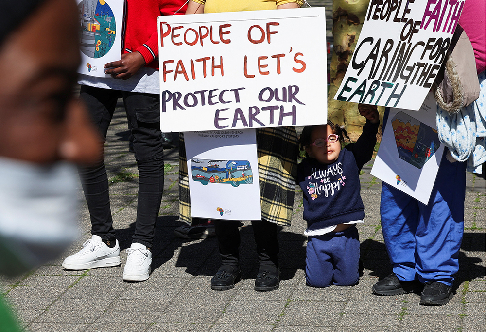 Climate activists in South Africa hold placards as they gather outside the Cape Town International Convention Center Sept. 13, during the Southern Africa Oil and Gas Conference to call for climate justice resistance against oil and gas corporations and an end to fossil fuels. (OSV News/Reuters/Esa Alexander)
