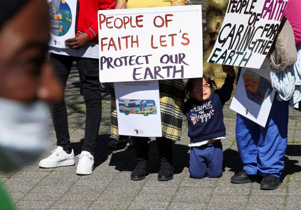 Climate activists in South Africa hold placards as they gather outside the Cape Town International Convention Center Sept. 13, 2023, during the Southern Africa Oil and Gas Conference to call for climate justice resistance against oil and gas corporations and an end to fossil fuels. (OSV News/Reuters/Esa Alexander)