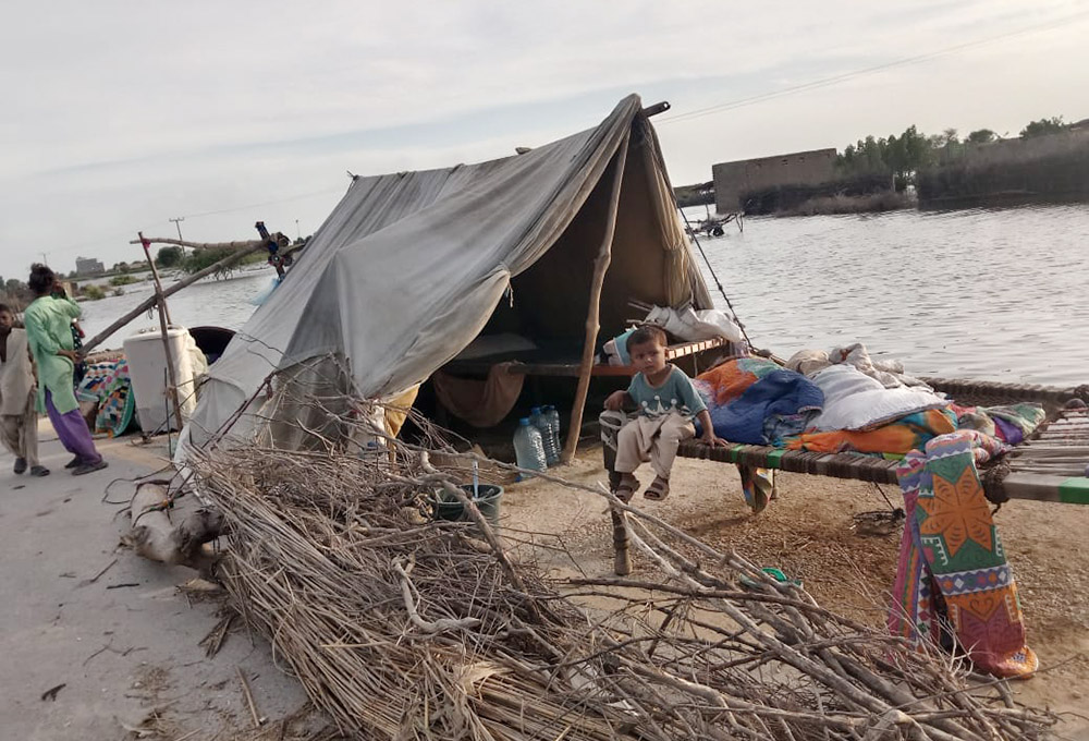 A family home beside floodwaters in the province of Sindh in Pakistan in 2022 (Courtesy of Emer Manning)