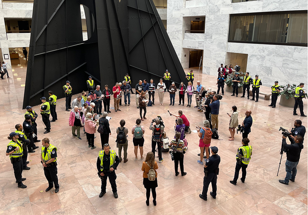 U.S. Capitol Police officers are seen surrounding Catholic activists holding a witness inside the Hart Senate Office Building on Nov. 9 to call for an Israel-Hamas cease-fire. (NCR photo/Joshua J. McElwee)