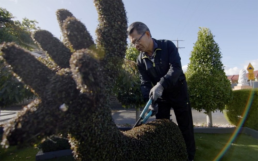 Bishop Vincent Long of Parramatta, Australia, works in his mother's garden. (Courtesy of Parramatta Diocese)