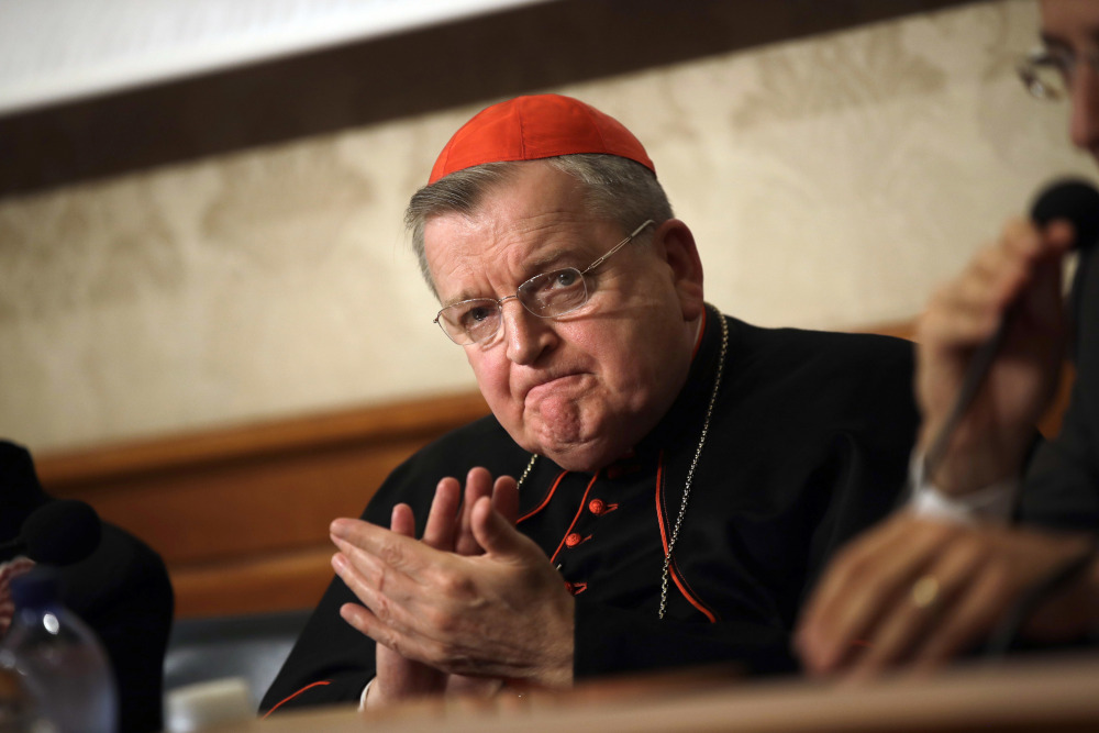 Cardinal Raymond Burke applauds during a news conference at the Italian Senate, in Rome, on Sept. 6, 2018. (AP Photo/Alessandra Tarantino, File)