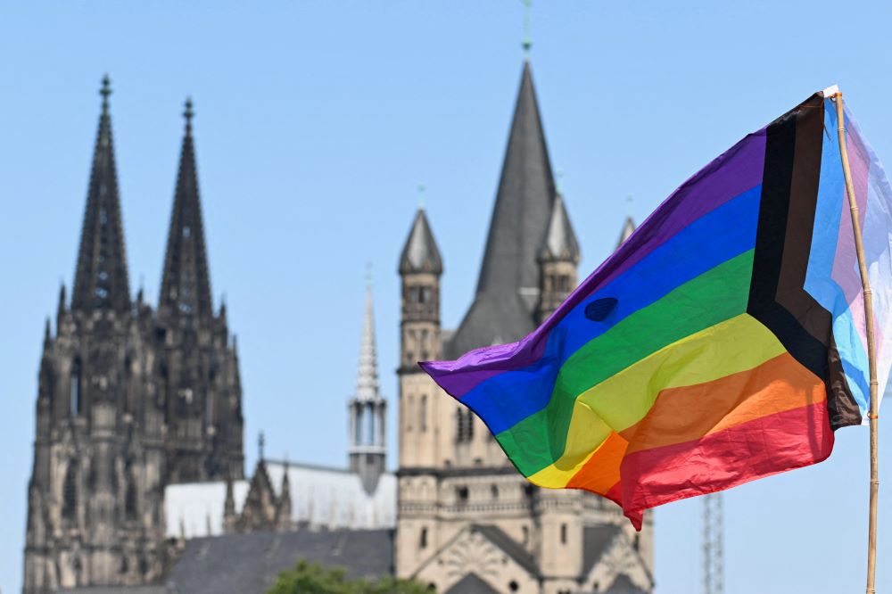 Rainbow flag with church steeples behind