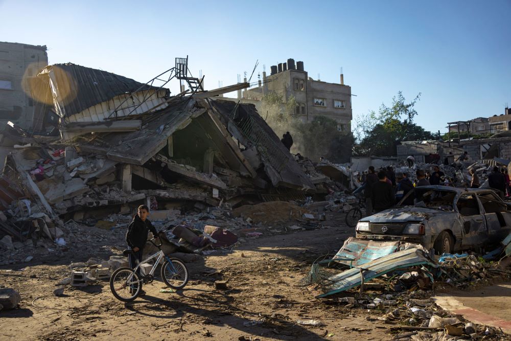 Palestinians search for bodies and survivors in the rubble of a residential building destroyed in an Israeli airstrike, in Rafah, southern Gaza Strip, on Dec. 15. (AP/Fatima Shbair)