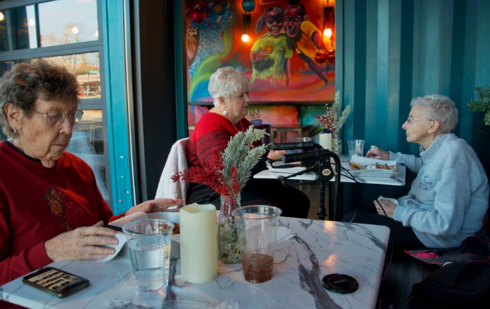 From left: Mercy Sr. JoAnn Persch, Mercy Associate Carol Conway and Mercy Sr. Pat Murphy enjoy lunch Dec. 13 between stops visiting migrant families they sponsor in Chicago. (GSR photo/Dan Stockman)