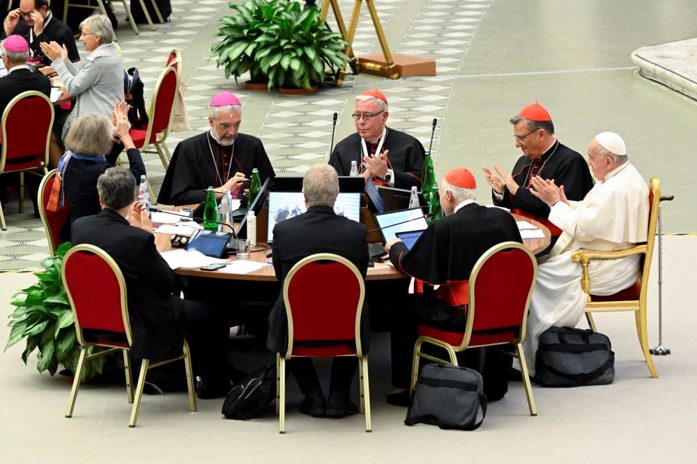 Pope Francis and leaders of the assembly of the Synod of Bishops applaud at the conclusion of the gathering's last working session of the synod on synodality Oct. 28 in the Paul VI Hall at the Vatican. (CNS/Vatican Media)