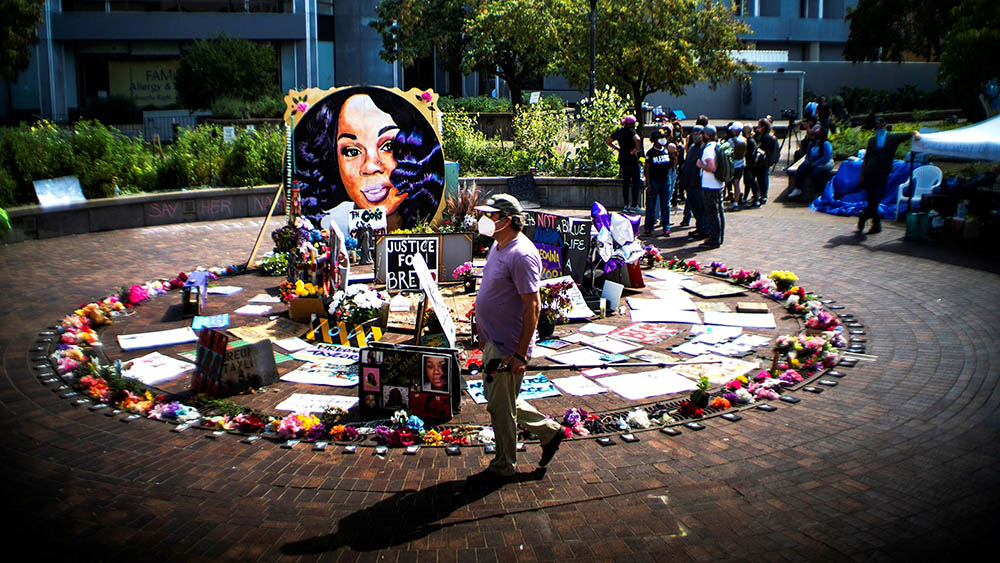 People in Louisville, Kentucky, gather near a memorial for Breonna Taylor Sept. 25, 2020. In March of that year, white police officers shot and killed Taylor, a 26-year-old Black emergency medical technician, during a raid on her home. (CNS/Reuters/Eduardo Munoz)