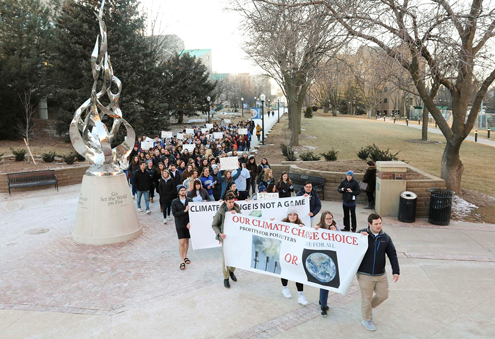 People rally at Creighton University Feb. 20, 2020, in Omaha, Nebraska, calling for the Jesuit-run school to fully divest from fossil fuels. (CNS/Courtesy of Emily Burke)