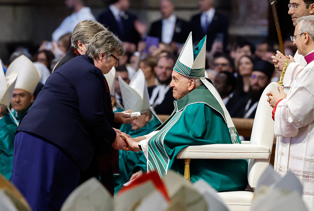 Pope Francis accepts the offertory gifts as he celebrates Mass marking the end of the first session of the assembly of the Synod of Bishops on synodality in St. Peter’s Basilica at the Vatican Oct. 29. (CNS/Lola Gomez)