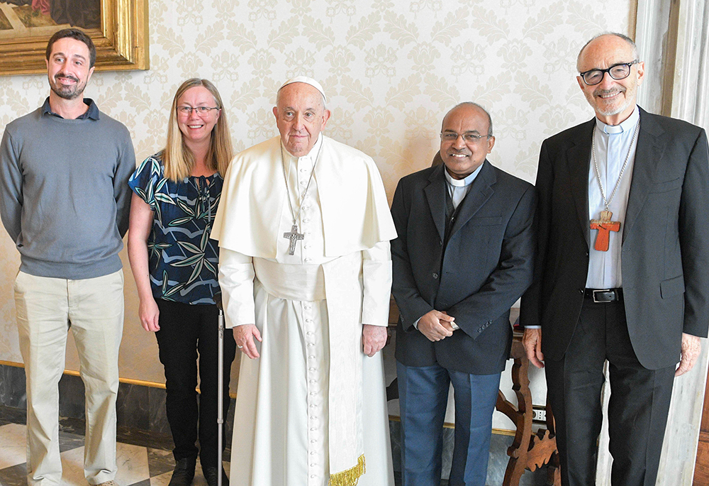 Pope Francis poses for a photo with leaders of the Laudato Si' Movement in the library of the Apostolic Palace at the Vatican Nov. 6. From left to right: Tomás Insua, Lorna Gold, Pope Francis, Jesuit Father Xavier Jeyaraj and Cardinal Michael Czerny, prefect of the Dicastery for Promoting Integral Human Development. (CNS/Vatican Media)