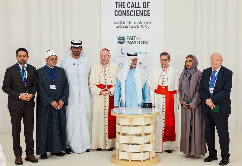 Cardinal Pietro Parolin, Vatican secretary of state, poses next to Sultan Ahmed al-Jaber, the president-designate of COP28, left, Sheikh Nahyan bin Mubarak Al Nahyan, the UAE Minister of Tolerance and Coexistence, center, and Cardinal Miguel Ángel Ayuso, prefect of the Dicastery for Interreligious Dialogue, and other representatives at the Faith Pavilion inauguration during COP28, Dec. 3 in Dubai, UAE. (CNS/Courtesy of U.N. Climate Change COP28/Christopher Pike)