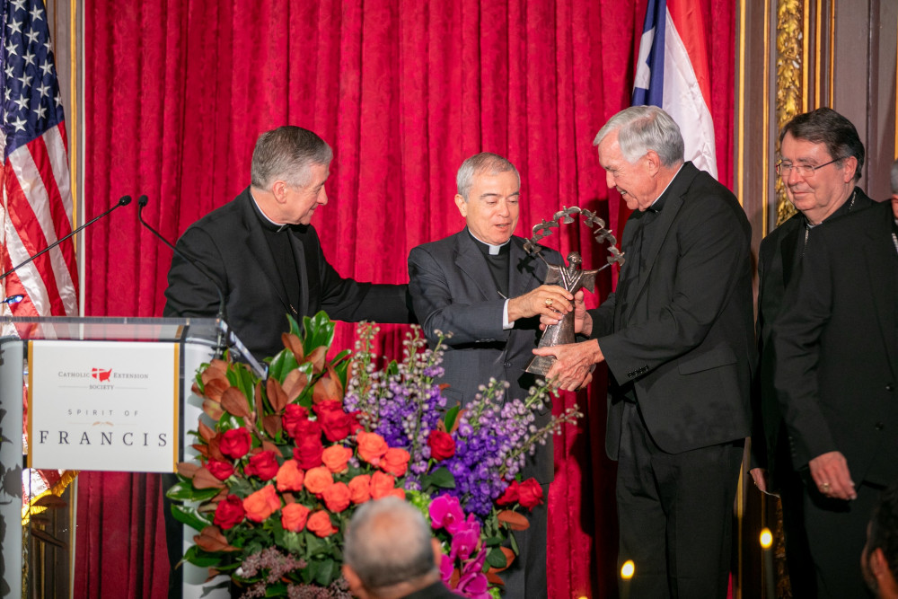 Fr. Jack Wall, president of Catholic Extension, presents Archbishop Roberto Gonzalez Nieves of San Juan, Puerto Rico, center, with Catholic Extension’s 2023 Spirit of Francis Award in New York City Nov. 28. Also pictured are Cardinals Blase Cupich of Chicago, left, and Christophe Pierre, nuncio to the United States. (OSV News photo/courtesy Catholic Extension)