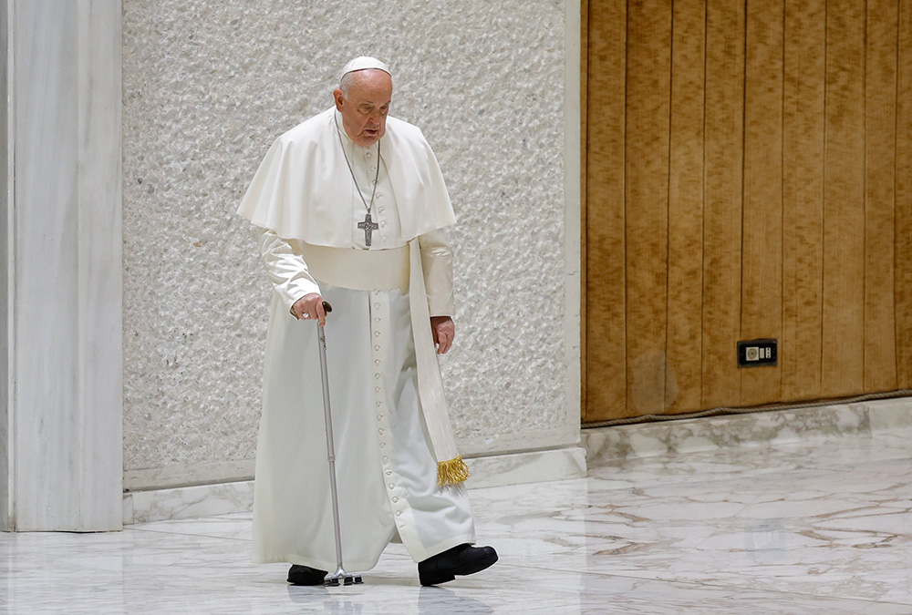 Pope Francis, walking with a cane, arrives in the Paul VI Audience Hall for his weekly general audience at the Vatican Dec. 6. (CNS/Lola Gomez)