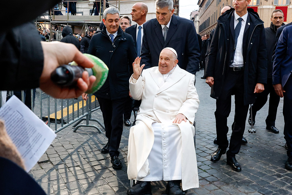 Pope Francis greets journalists gathered near a Marian statue by the Spanish Steps in Rome Dec. 8, the feast of the Immaculate Conception. (CNS/Lola Gomez)