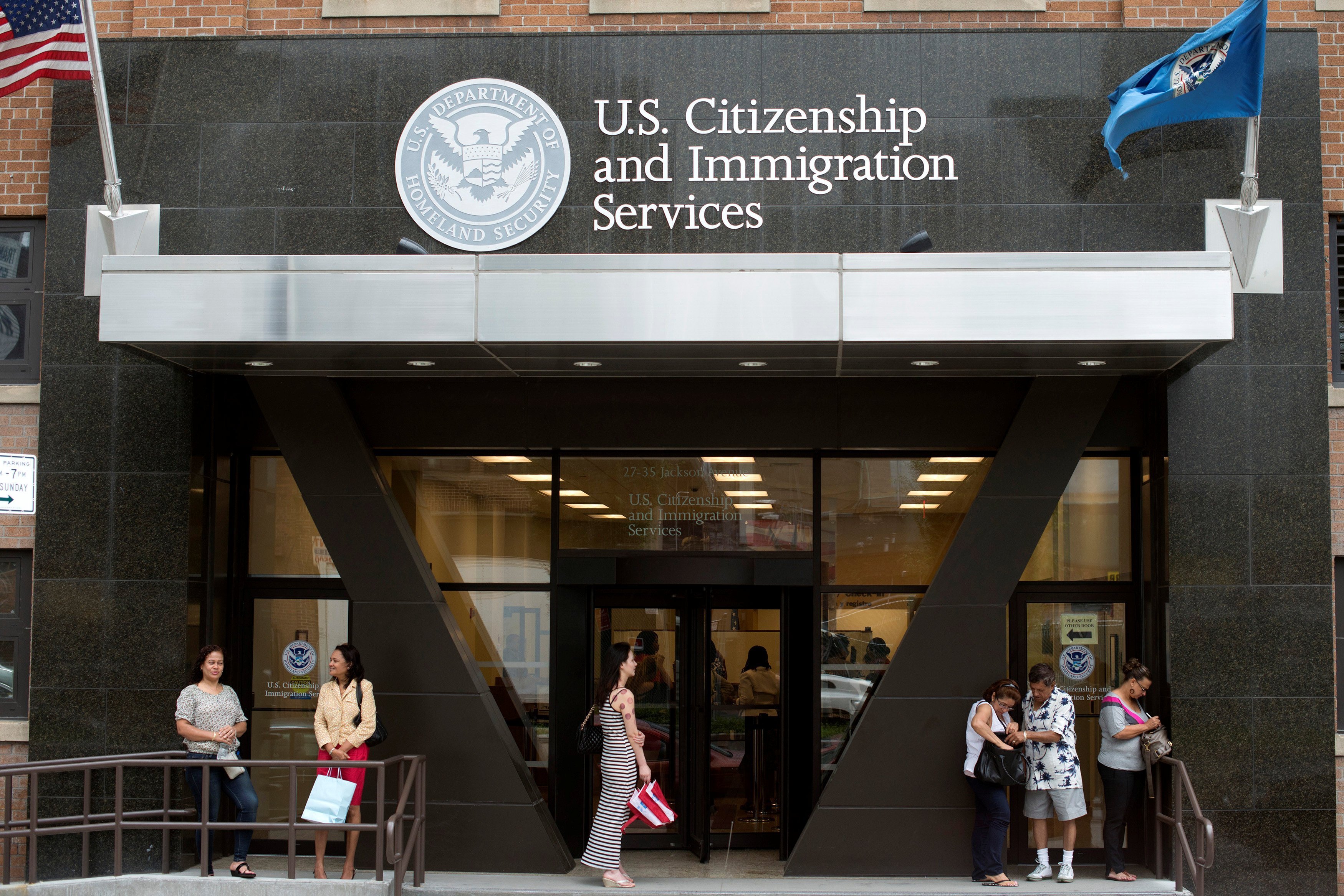 People are pictured in a file photo standing on the steps of the U.S. Citizenship and Immigration Services office in New York City. The federal government has made a procedural change in how it processes green cards for foreign-born religious workers, meaning some foreign-born priests and religious sisters and brothers relied upon by U.S. dioceses may not be able to remain in the country. (OSV News photo/Keith Bedford, Reuters)