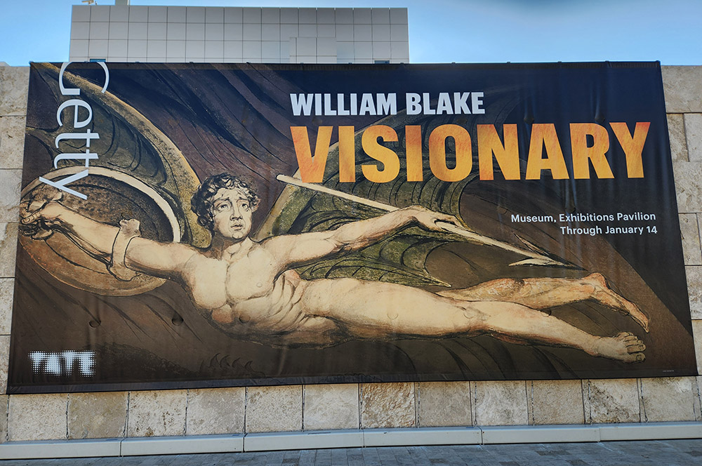 An outdoor banner for the exhibit "WIlliam Blake: Visionary," at the G. Paul Getty Museum in Los Angeles, features a detail of the 1795 print "Satan Exulting over Eve." The exhibit is on display through Jan. 14, 2024. (NCR photo/Chris Herlinger)