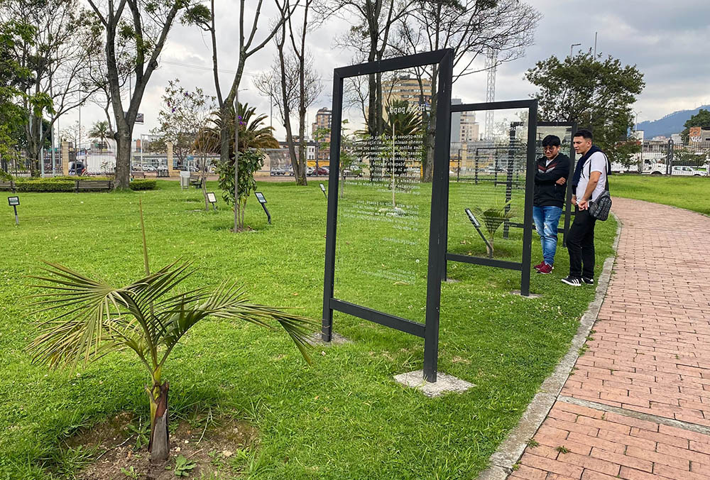 Dos hombres. detenidos frente a una cartelera ubicada en las adyacencias del Centro de Memoria, Paz y Reconciliación en Bogotá, leen el texto de algunas cartas escritas por quienes conocieron a víctimas del conflicto civil de Colombia, Los textos expresan el dolor de quienes sufrieron la pérdida de sus seres queridos o que no saben, décadas después de su desaparición, qué pasó con ellos. (Foto: GSR/Rhina Guidos)