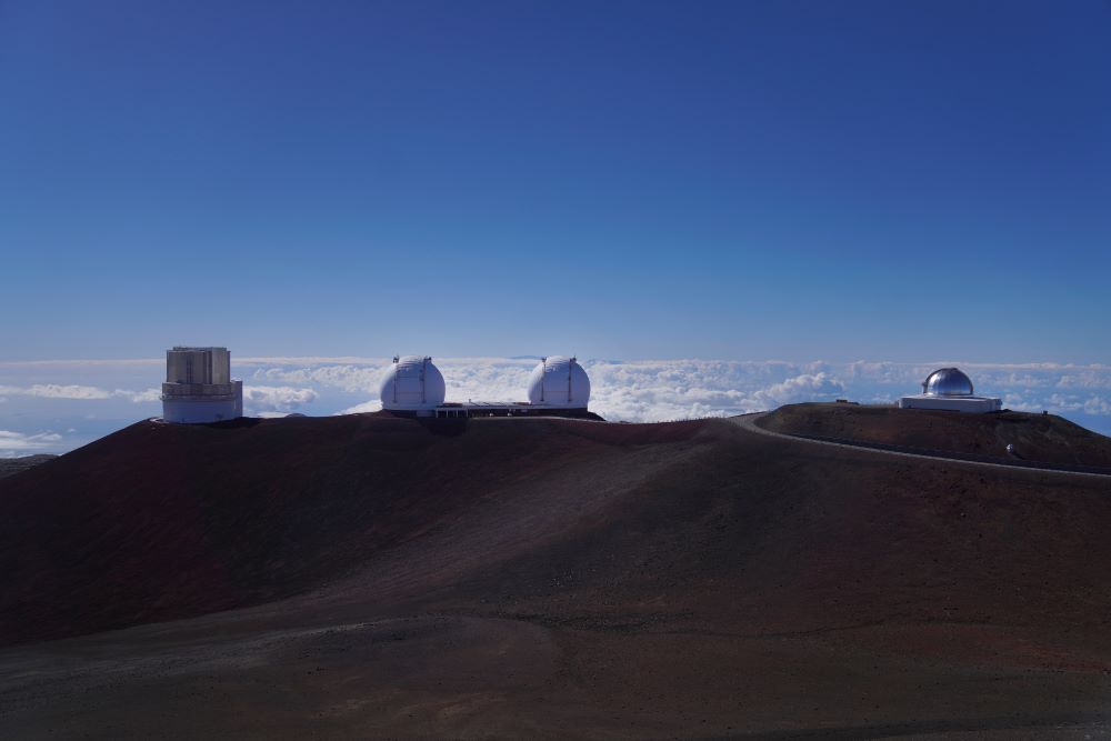 From left, Subaru Telescope, W.M. Keck Observatory, and the NASA Infrared Telescope Facility sit on the summit of Mauna Kea in Hawaii, on Saturday, July 15, 2023. Over the last 50 years, astronomers have mounted 13 giant telescopes on Mauna Kea's summit. In 2009, they proposed an even larger Thirty Meter Telescope, which spurred lawsuits and protests by Native Hawaiian activists. (AP/Jessie Wardarski)