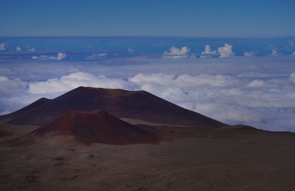 The summit of Mauna Kea on the Big Island of Hawaii, on Saturday, July 15, 2023. Mauna Kea was born after a series of volcanic eruptions from the ocean floor created new land. Over a million years, it grew into the tallest mountain on earth when measured from its base in the Pacific Ocean to its summit soaring 13,796 feet (4,205 meters) above sea level. (AP Photo/Jessie Wardarski)