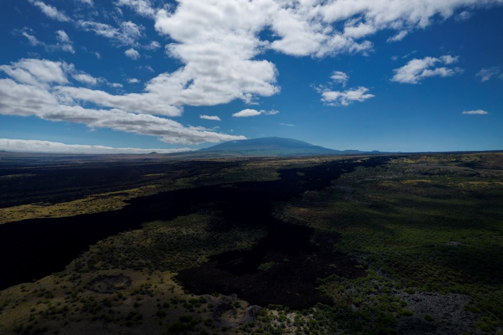 The sacred mountain of Mauna Kea on the Big Island of Hawaii, on Monday, July 17, 2023. Mauna Kea was born after a series of volcanic eruptions from the ocean floor created new land. Over a million years, it grew into the tallest mountain on earth when measured from its base in the Pacific Ocean to its summit soaring 13,796 feet ((4,205 meters) above sea level. (AP Photo/Jessie Wardarski)