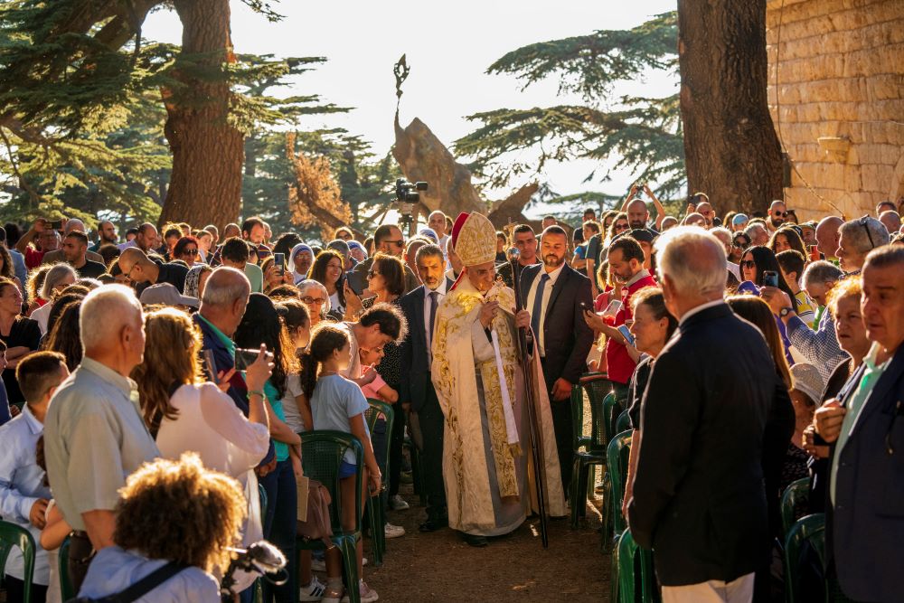 People greet Lebanese Maronite Christian Patriarch Beshara al-Rai, center, as he arrives to start the sermon to commemorate the Feast of the Transfiguration in the Cedars of God forest, in the northeast mountain town of Bcharre, Lebanon, Saturday, Aug. 5, 2023. (AP/Hassan Ammar)