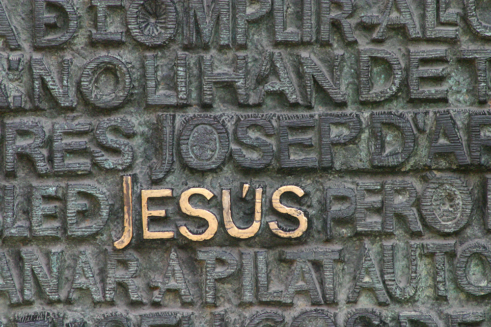 The word Jesus in gold on stone (Unsplash/Mark Fletcher Brown)