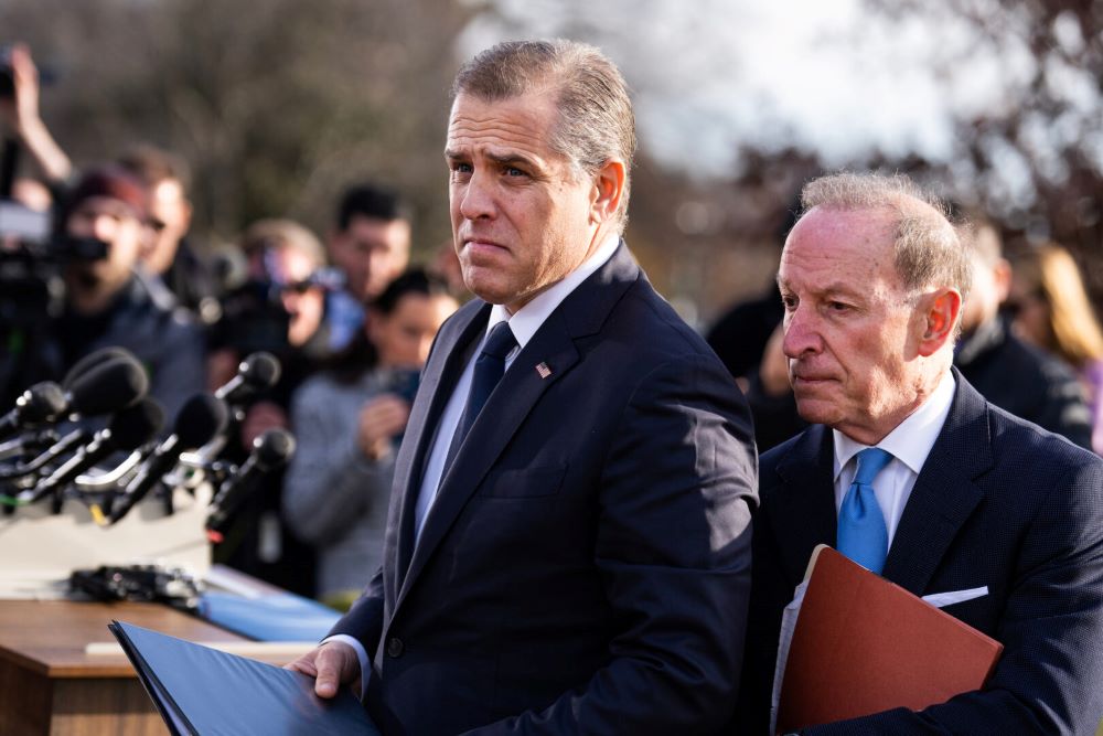 Attorney and businessman Hunter Biden, left, and lawyer Abbe Lowell are surrounded by reporters asking about Biden's potential testimony before the House of Representatives about his foreign business dealings. (Wikimedia Commons/CQ Roll Call/Tom Williams)
