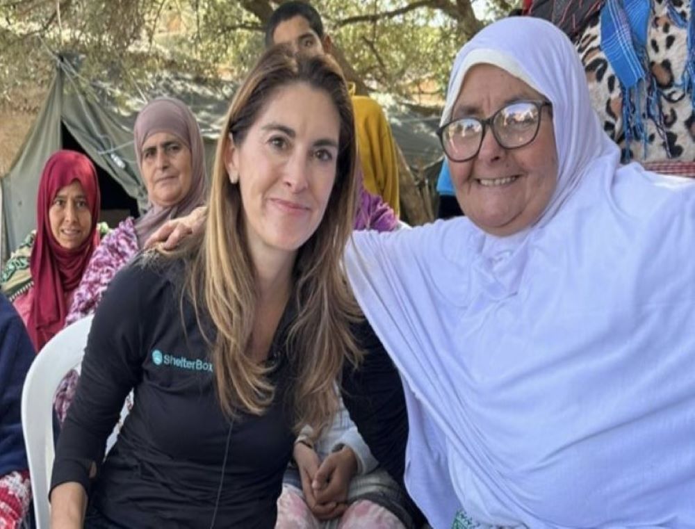 Kerri Murray, president of ShelterBox USA, sits with Fadma, whose husband was crushed in the Sept. 8 earthquake in Morocco. Murray gave the widow relief supplies, and Fadma — wearing white as a sign of mourning — took Murray to the site of her destroyed home.