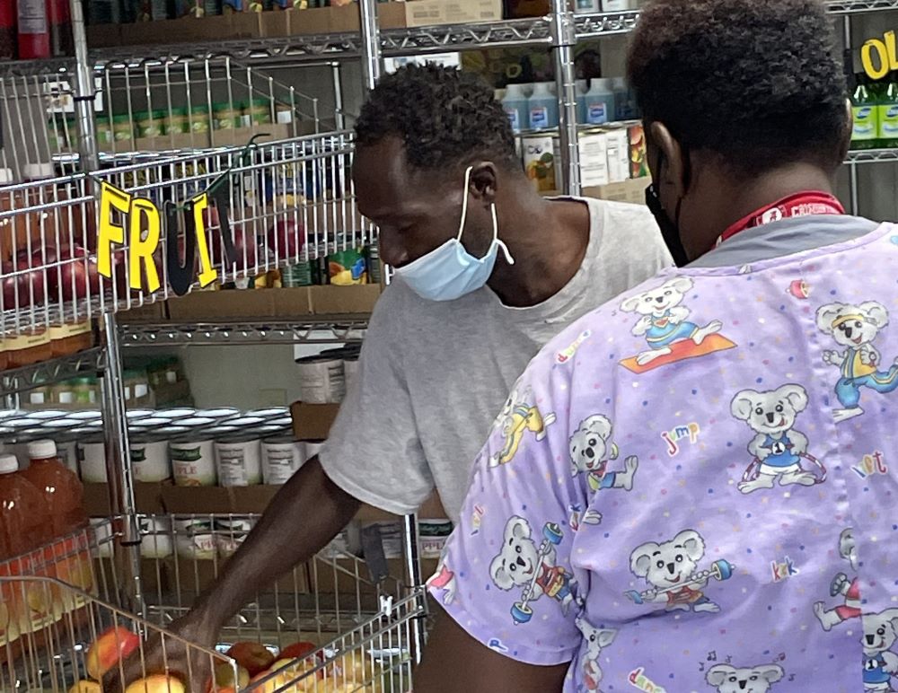 Shoppers select fresh peppers at the Good Shepherd Food Market in Mosses, Alabama, where free groceries are available through a project of the Edmundite Missions. 