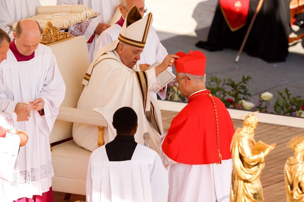 Pope Francis gives the red biretta to new Cardinal Robert Prevost, the U.S.-born prefect of the Dicastery for Bishops, during a consistory for the creation of 21 new cardinals in St. Peter's Square at the Vatican in this file photo from Sept. 30. (CNS/Lola Gomez)