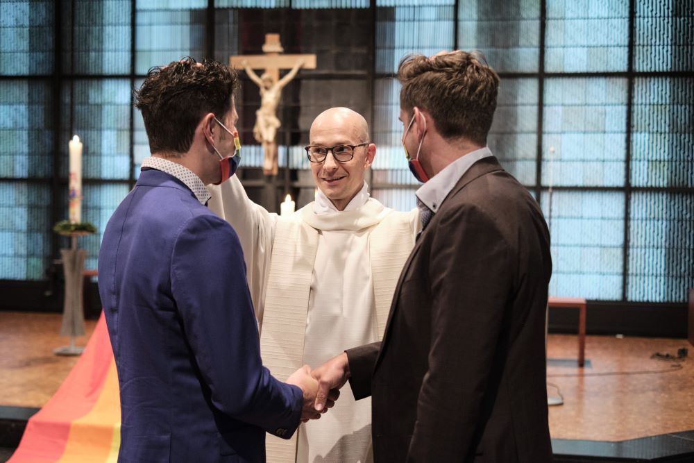 Fr. Christian Olding blesses a gay couple during a blessing service called "Love Wins" in the Church of St. Martin in Geldern, Germany May 6, 2021.
