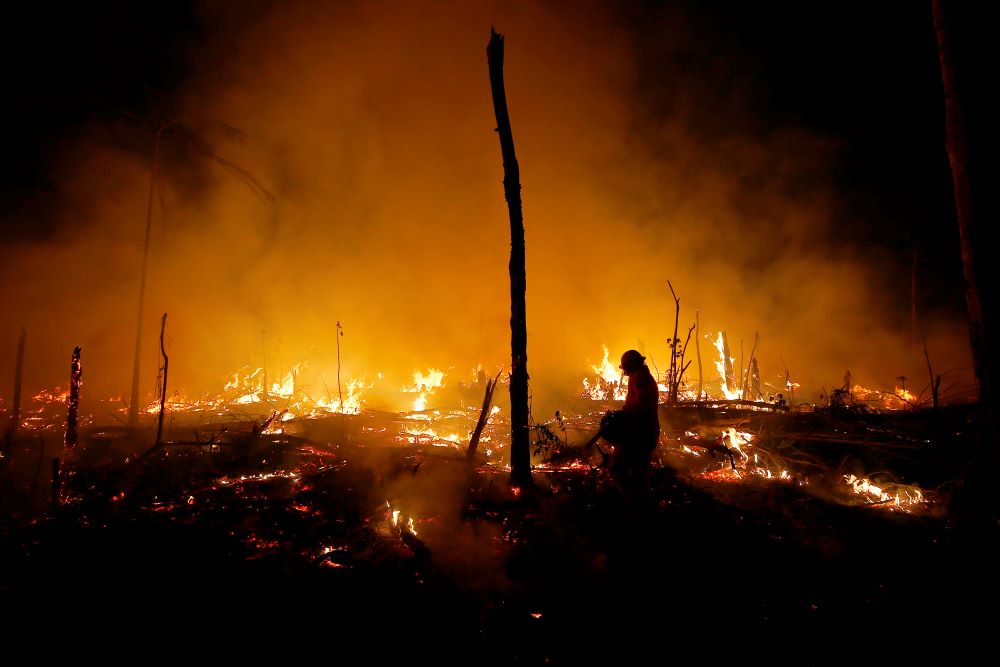 Firefighters work to put out a blaze in the Amazon forest during a drought and high temperatures in the rural municipality of Careiro Castanho, Amazonas state, Brazil, on Oct. 21.