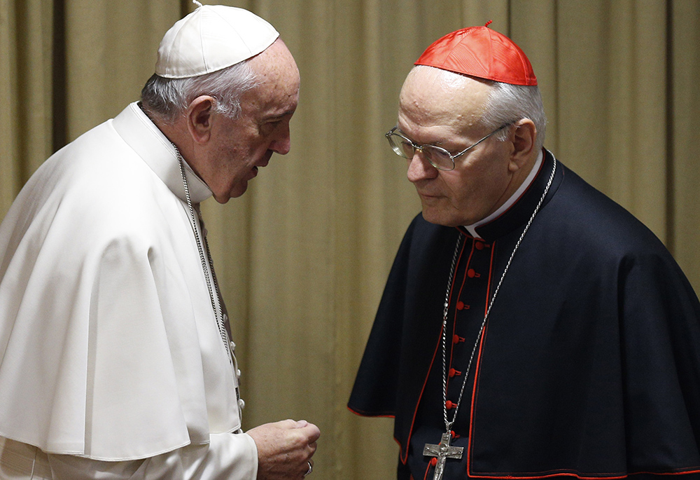 Pope Francis talks with Cardinal Peter Erdo of Esztergom-Budapest, Hungary, relator for the extraordinary Synod of Bishops, before a synod session at the Vatican Oct. 24, 2015. (CNS/Paul Haring)