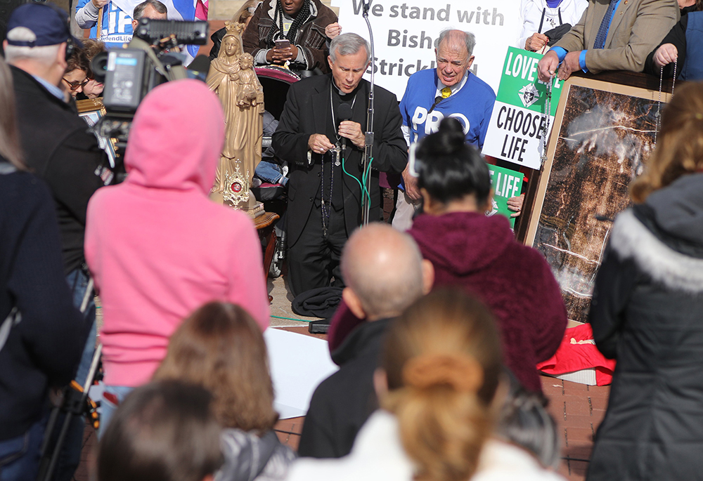 Bishop Joseph Strickland, who was removed from pastoral governance of the Diocese of Tyler, Texas, by Pope Francis Nov. 11, 2023, leads the recitation of the rosary Nov. 15 outside the site of the fall general assembly of the U.S. Conference of Catholic Bishops in Baltimore. (OSV News/Bob Roller)