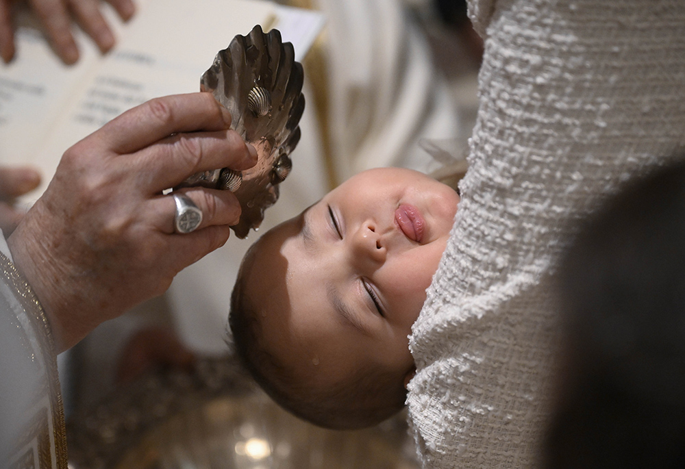 Pope Francis baptizes a baby during Mass in the Sistine Chapel at the Vatican Jan. 7, 2024, the feast of the Baptism of the Lord. (CNS/Vatican Media)