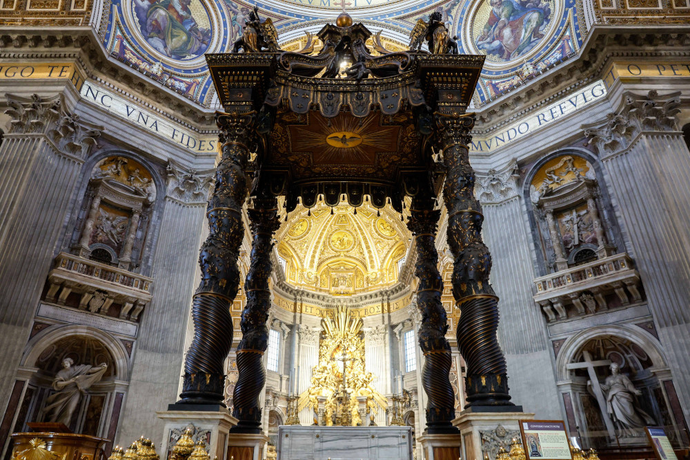 The baldachin, an ornate, dark-colored four-posted covering, is seen above the altar at St. Peter's Basilica