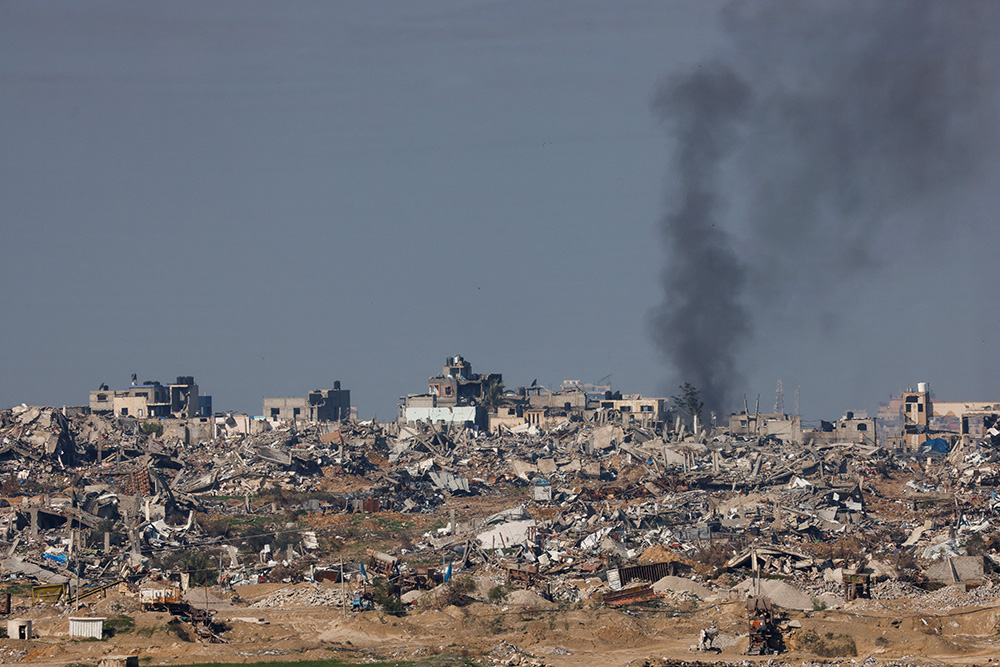 Smoke rises over Gaza as seen from Israel Jan. 16, 2024, amid the ongoing conflict between Israel and the Palestinian Islamist group Hamas. Violence and attacks have spread throughout the Middle East region, including Iran's launch of ballistic missiles late Jan. 15, 2024, on neighborhoods of Irbil, the capital of Iraqi Kurdistan, which has left the Iraqi Catholic community feeling unsettled. (OSV News/Reuters/Amir Cohen)